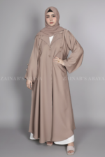 Nida Coat Style Abaya for women in Pakistan with stylish button style on front and sleeves as well as a matching scarf in chiffon fabric.