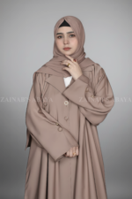 Nida Coat Style Abaya for women in Pakistan with Button Style on Front and Sleeves as well as a matching scarf in Chiffon Fabric.