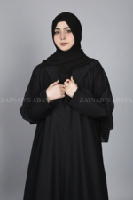 Black Coat Style Abaya for women in Pakistan is crafted with Premium Nida Korean Fabric and button style sleeves.