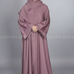 Nida Kasni Colored Front Open Abaya for women in Kasni with Embroidered Sleeves as well as a matching scarf.