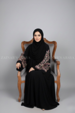 Nida Umbrella Abaya for women in Pakistan featuring arabic embroidery includes a matching scarf in chiffon fabric.