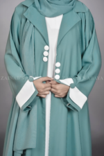 Nida Coat Style Abaya with Inner in Pakistan featuring the smart coat collar style, button style on front and sleeves and comes with a matching scarf in chiffon fabric.