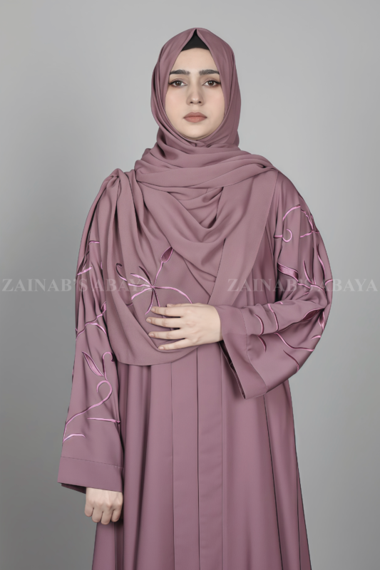 Nida Front Open Abaya for women in Pakistan features the stylish embroidered sleeves and a matching scarf in chiffon fabric.