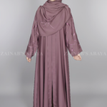 Nida Front Open Abaya for women in Pakistan features the stylish embroidered sleeves and a matching scarf in chiffon fabric.