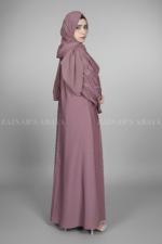 Nida Front Open Abaya for women in Pakistan features the stylish embroidered sleeves and a matching scarf in chiffon fabric.