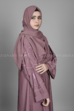Nida Front Open Abaya for women in Pakistan features elegant embroidered sleeves and comes with a matching scarf in chiffon fabric.