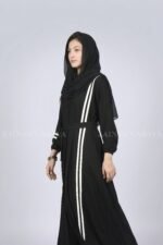 Black modern maxi abaya with an elegant strip design on one side, offering a sleek and stylish look.