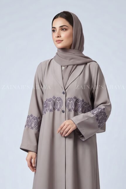 Coat Style Abaya in Light Grey Color featuring embroidery as well as matching scarf in chiffon fabric.