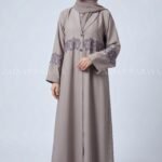 Coat Style Abaya in Light Grey Color featuring embroidery as well as matching scarf in chiffon fabric.