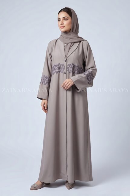 Coat Style Abaya in Light Grey Color featuring embroidery as well as matching scarf in chiffon fabric.