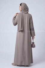 Coat Style Abaya in Light Grey Color featuring embroidery as well as matching scarf in chiffon fabric.